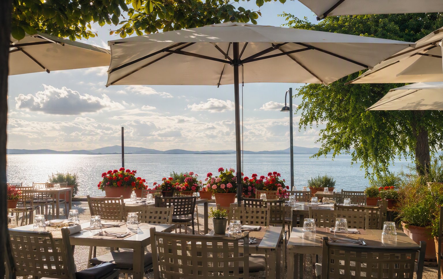 La terrazza con gli ombrelloni affacciata sul Trasimeno